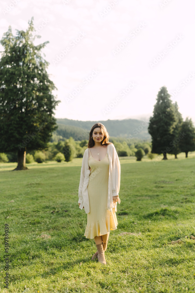 Young woman standing in field in summer Young woman standing in field in summer