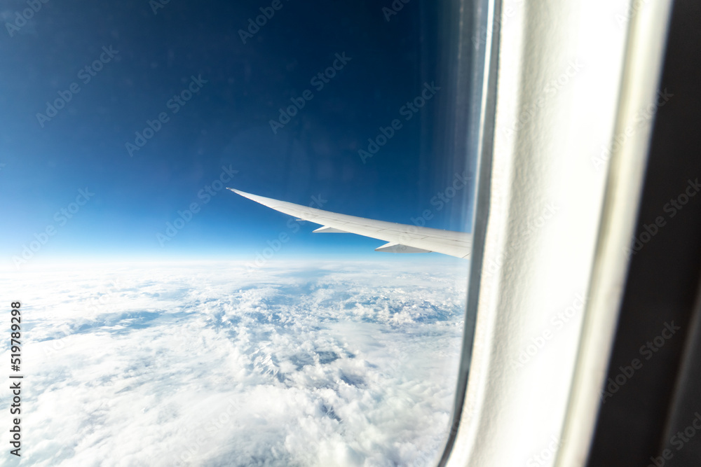 View out of a Boeing 787 window while flying over snow-covered mountains. View out of a Boeing 787 window while flying over snow-covered mountains.