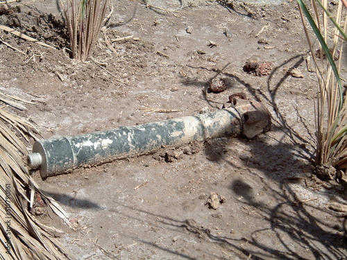 Old rocket in the dirt on Camp Slayer, in Baghdad, Iraq