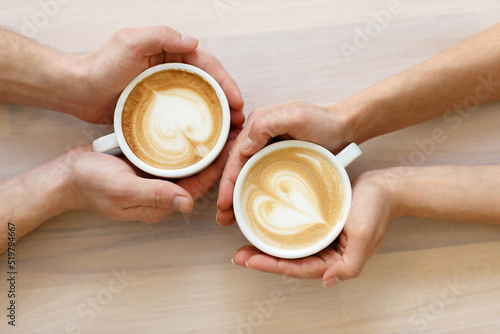 Couple drinking coffee in a cafe man and woman with a cup of hot latte. Flat lay.