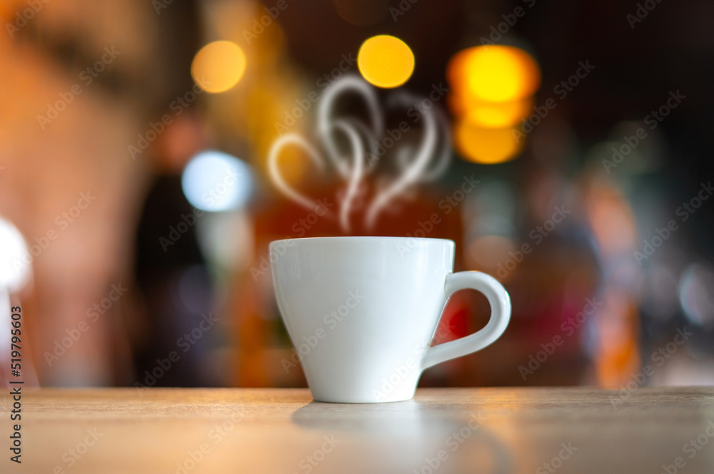 Hot Coffee Cup on Wood Table in blurred Coffee Shop background. Hot Coffee Cup on Wood Table in blurred Coffee Shop background.