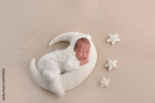 A cute newborn is lying in bed. baby sleep with the stars
