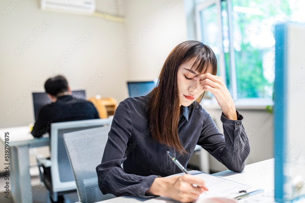 A business woman tired of office work A business woman tired of office work