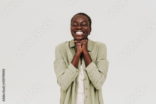 Young black woman with afro braids smiling at camera