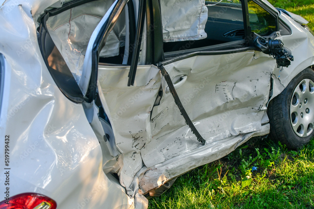 Car accident. White microcar heavily damaged on the side, with airbags