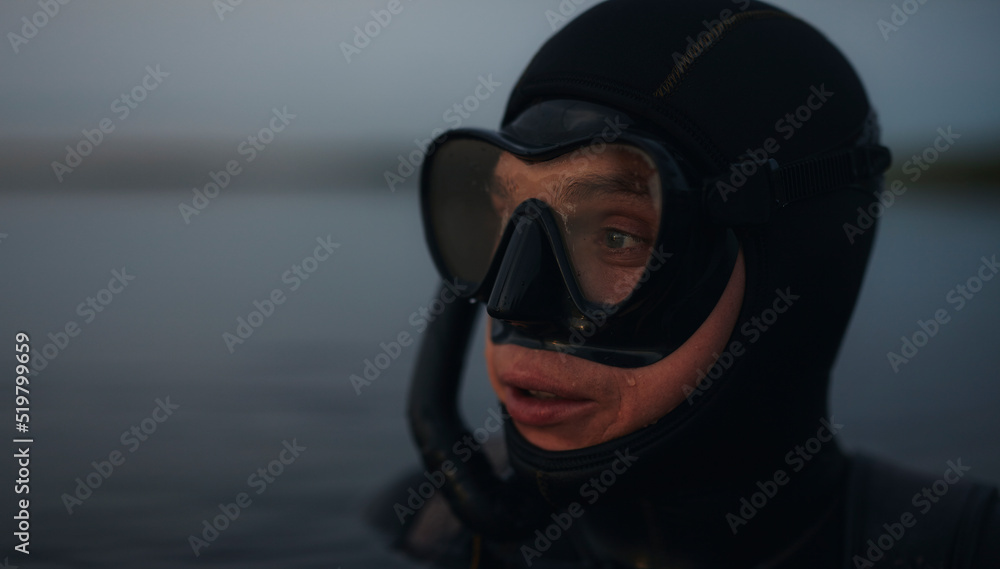 Scuba diver looking away while submerged in sea water Scuba diver looking away while submerged in sea water