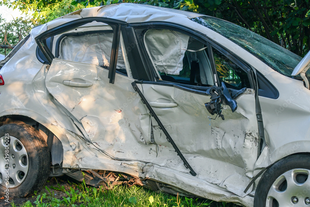 Car accident. White microcar heavily damaged on the side, with airbags