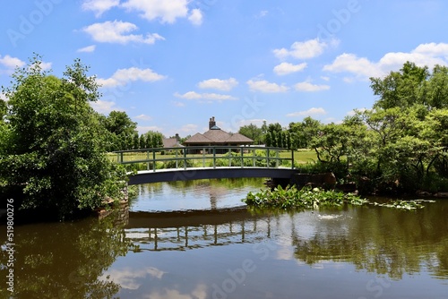 The wood bridge over the the pond in the countryside.