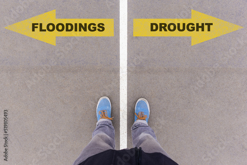 Flooding or Drought choice, text on asphalt ground, feet and shoes on floor photo