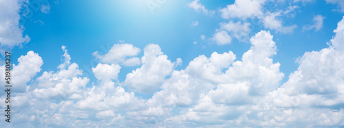Abstract white puffy clouds and blue sky background. © natara