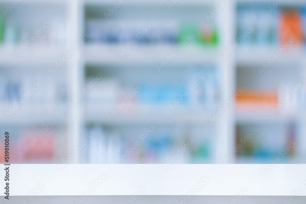 Empty white counter with pharmacy drugstore shelves blurred background