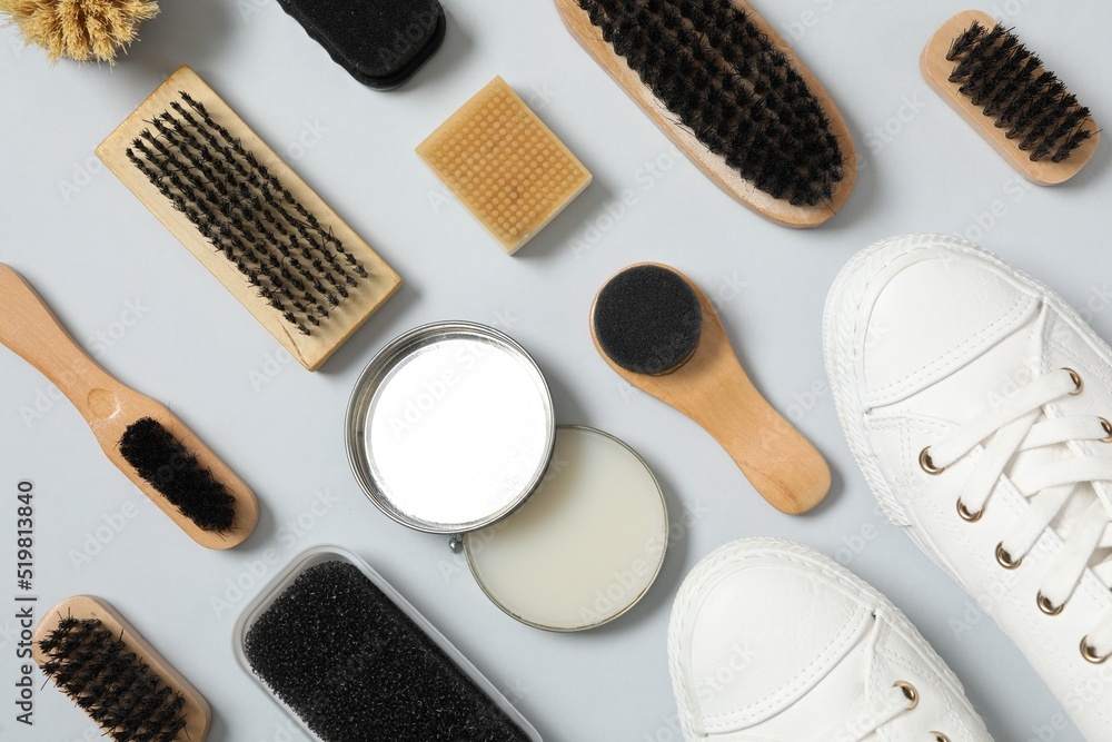Flat lay composition with stylish footwear and shoe care accessories on white background Flat lay composition with stylish footwear and shoe care accessories on white background