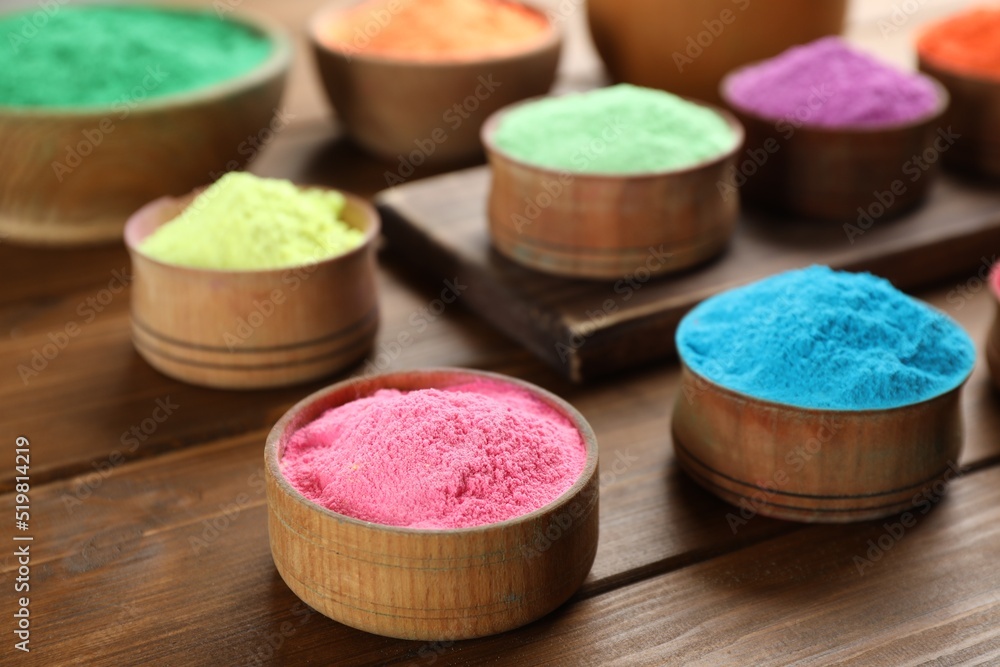Colorful powder dyes on wooden background, closeup. Holi festival Colorful powder dyes on wooden background, closeup. Holi festival