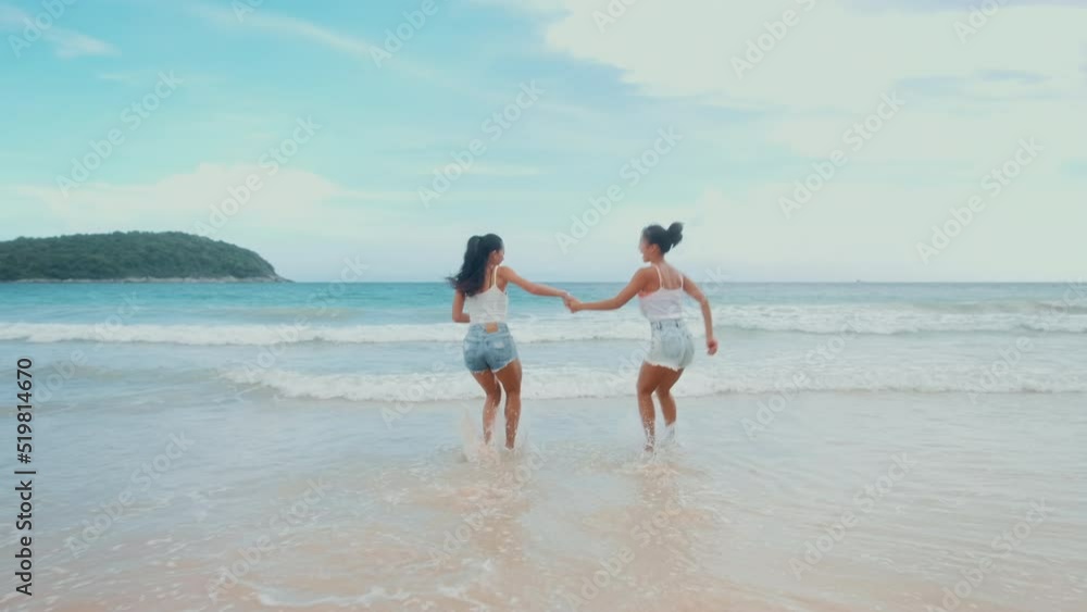 Two attractive women friends enjoying and relaxing on the beach, Summer, vacation, holidays, Lifestyles concept Two attractive women friends enjoying and relaxing on the beach, Summer, vacation, holidays, Lifestyles concept