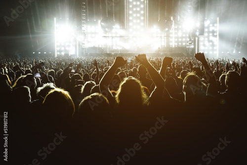 Print op canvas People with raised hands at a music concert