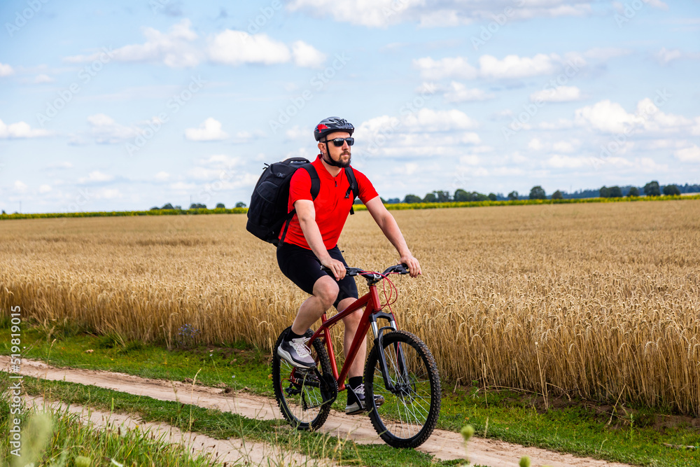 bike adventure travel photo. bike tourist rides on the country road bike adventure travel photo. bike tourist rides on the country road