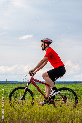 bike adventure travel photo. bike tourist rides on the country road. Vertical photo shot