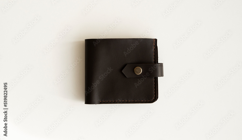 Top view of new dark brown genuine leather wallet with banknotes and credit card inside isolated on white background. Top view of new dark brown genuine leather wallet with banknotes and credit card inside isolated on white background.