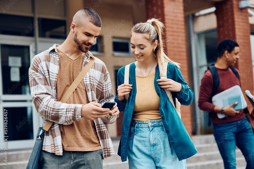 Happy university students using cell phone at campus. Happy university students using cell phone at campus.