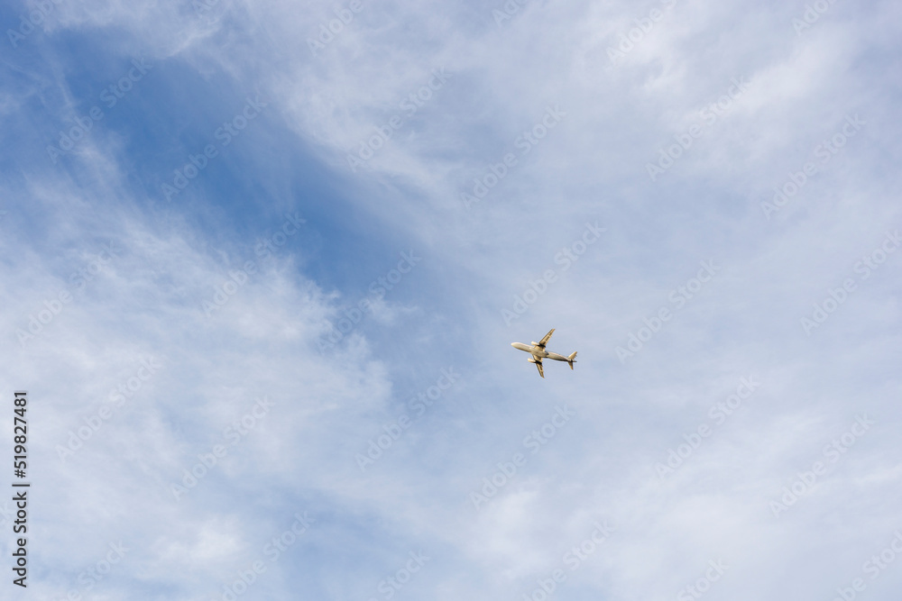 Small airplane flying in the clouds over the blue sky Small airplane flying in the clouds over the blue sky