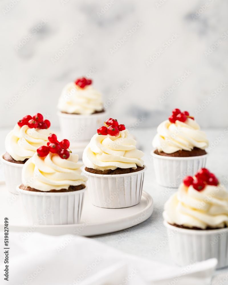 Vanilla cupcakes on white wood background, copy space Vanilla cupcakes on white wood background, copy space