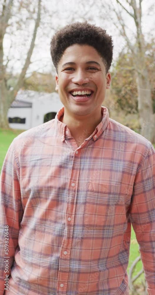 Vertical video of happy biracial man smiling at camera Vertical video of happy biracial man smiling at camera
