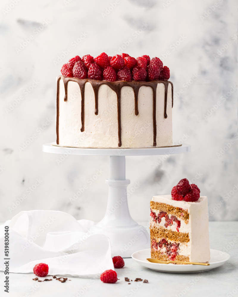 Raspberry cake, raspberry sponge cake with fresh raspberries and sour cream on a white background