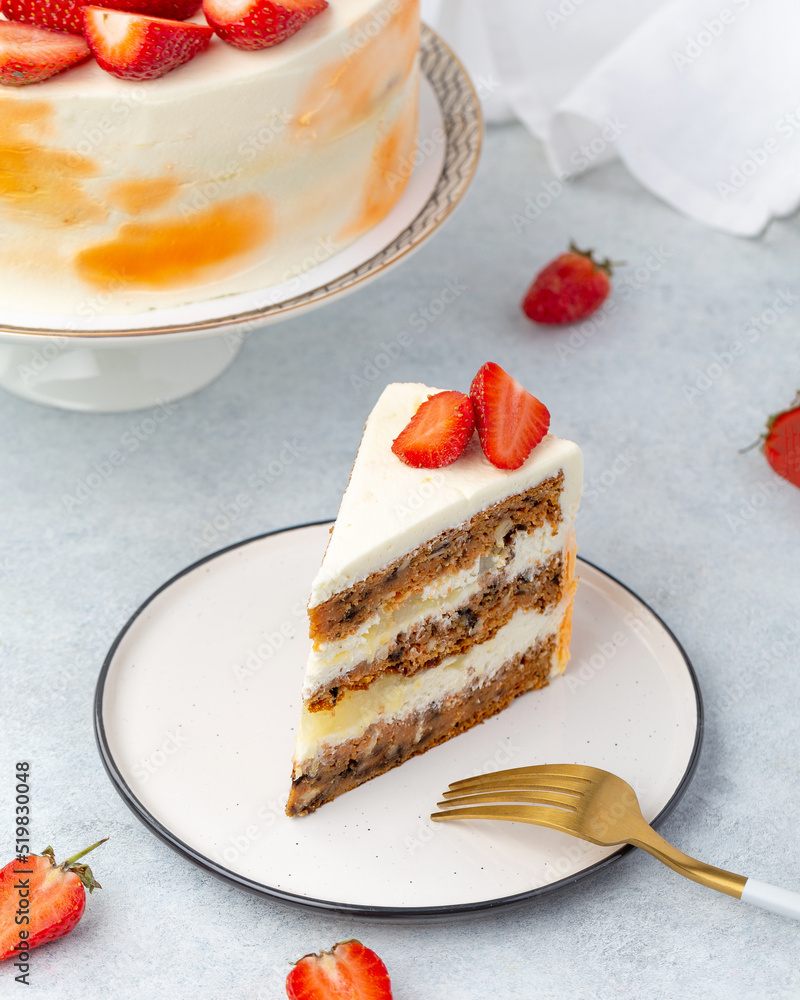 Piece of Strawberry cake with fresh strawberries and sour cream on a white background.