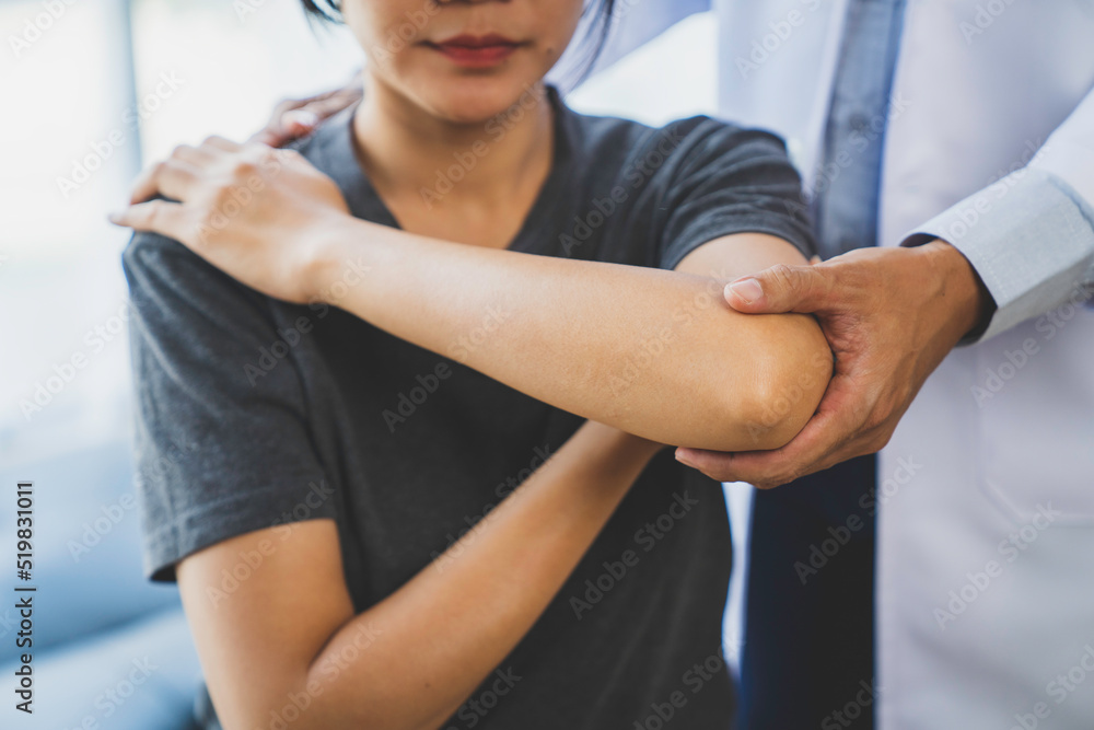 Physicians consulting patients about elbow muscle pain problem, office syndrome problems, physiotherapy diagnosis concept Physicians consulting patients about elbow muscle pain problem, office syndrome problems, physiotherapy diagnosis concept