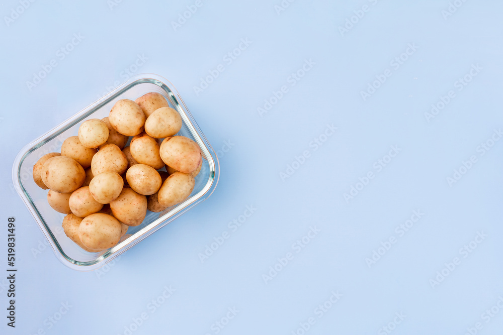 Glass box with fresh raw potatoes. Vegetables in a glass containers. Food storage concept Glass box with fresh raw potatoes. Vegetables in a glass containers. Food storage concept