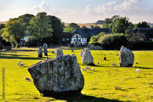 Avebury Neolithic henge and stone circles, Wiltshire, England. 5600 years old. Over inner South Circle toward village pub photo