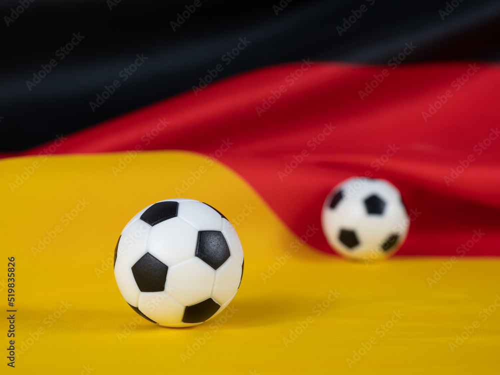 Soccer ball on the German flag. The ball against the background of the German flag. Soccer ball on the German flag. The ball against the background of the German flag.
