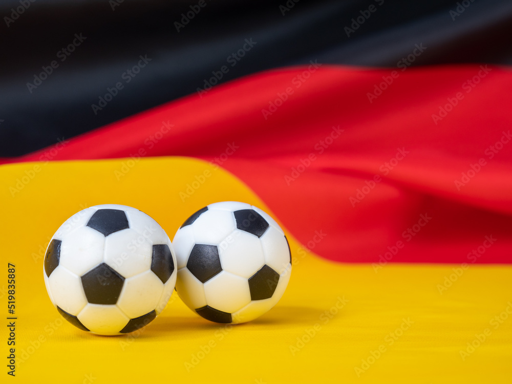 Soccer ball on the German flag. The ball against the background of the German flag. Soccer ball on the German flag. The ball against the background of the German flag.