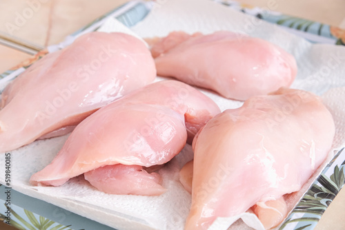 Chicken fillets after washing are dried on a paper towel for further freezing.