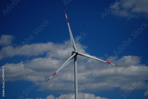 Propeller of windmill on the cloudy sky background