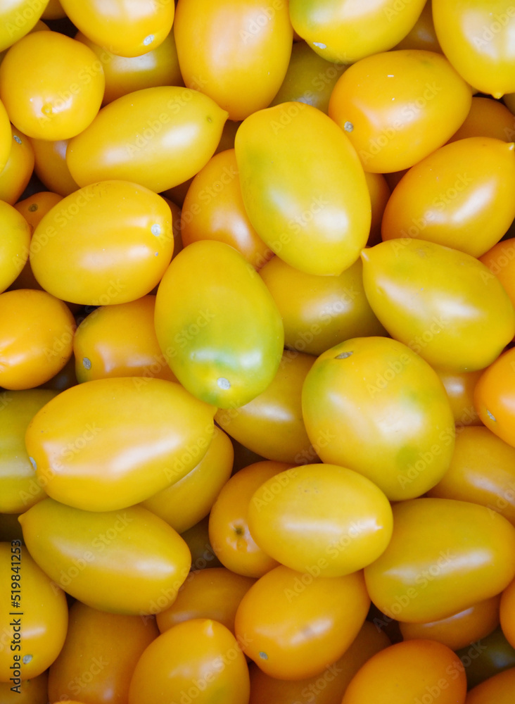 Ripe yellow tomatoes of the new harvest are sold at the bazaar Ripe yellow tomatoes of the new harvest are sold at the bazaar
