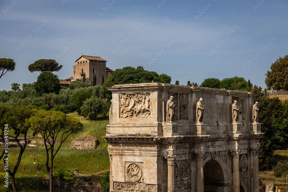The Arc of Constantine with a villa in the distance on the Palatine Hill in Rome, Italy. The Arc of Constantine with a villa in the distance on the Palatine Hill in Rome, Italy.