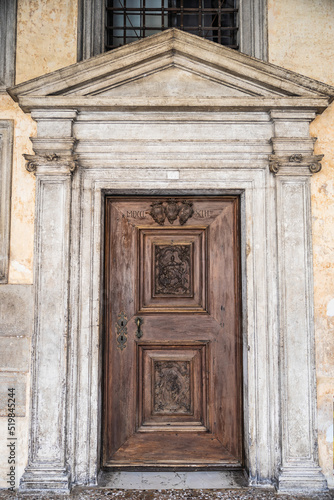 An old, weathered wooden door with an artistic frame in Venice. © Jason Yoder