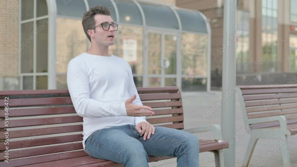 Angry Young Man Feeling Frustrated while Sitting Outdoor on Bench Angry Young Man Feeling Frustrated while Sitting Outdoor on Bench