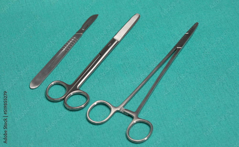 Sterile instruments on a green background close-up. Preparing instruments for surgery. Sterile instruments on a green background close-up. Preparing instruments for surgery.