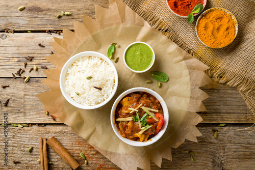kadai chicken indian food or indian curry with mint sauce on wooden background top view photo