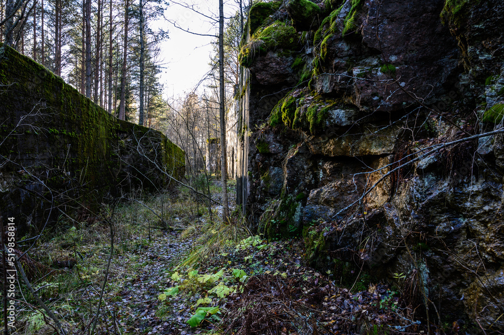 Obraz premium Passage through a granite rock. concrete structure. Passage to the powder cellar.