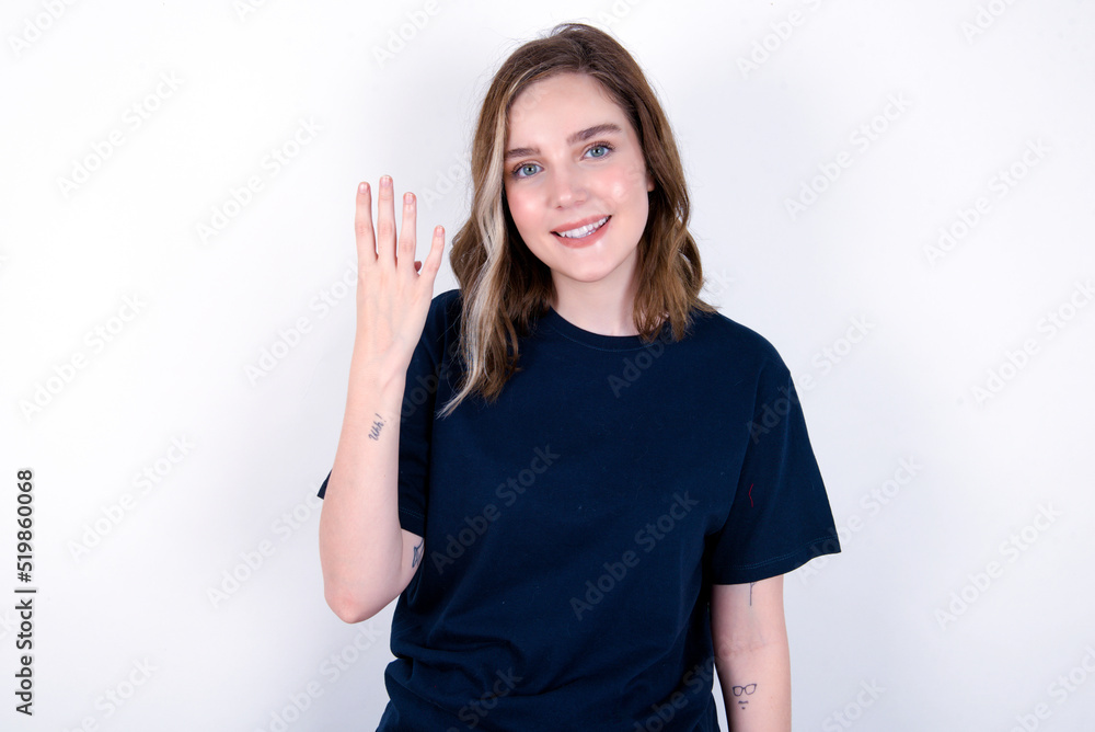 young caucasian woman wearing black T-shirt over white background smiling and looking friendly, showing number four or fourth with hand forward, counting down young caucasian woman wearing black T-shirt over white background smiling and looking friendly, showing number four or fourth with hand forward, counting down