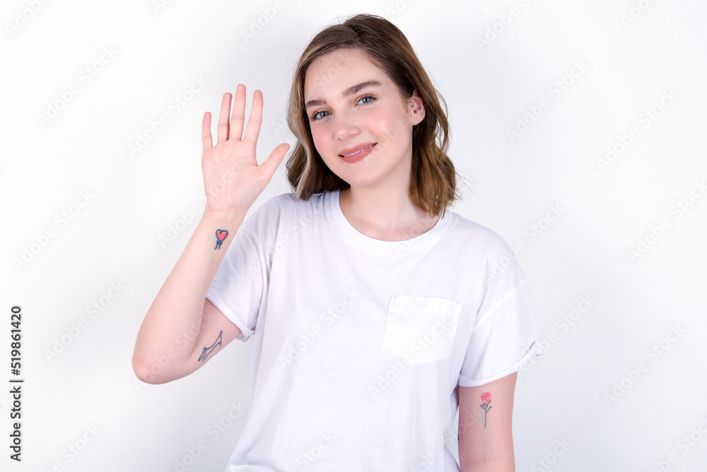 young caucasian woman wearing white T-shirt over white background showing and pointing up with fingers number five while smiling confident and happy. young caucasian woman wearing white T-shirt over white background showing and pointing up with fingers number five while smiling confident and happy.
