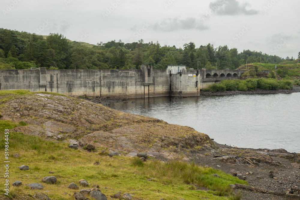 The dam at loch Doon in Carrick Scotland. This structure was built to create a hydroelectric generator which raised the water level making dramatic outdoor scenery popular for walkers and fishing The dam at loch Doon in Carrick Scotland. This structure was built to create a hydroelectric generator which raised the water level making dramatic outdoor scenery popular for walkers and fishing