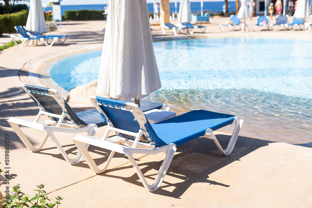 Fototapeta premium Swimming pool, sunbeds, water surface