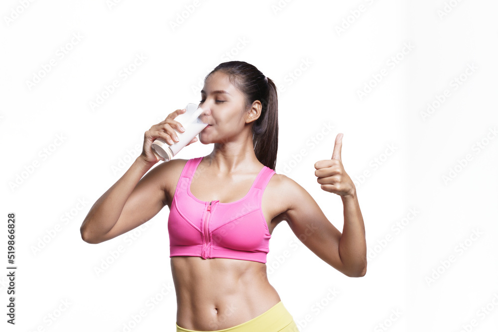 Asian healthy sport woman smiling while drinking white milk and thumb up. Beautiful girl stay good health and strong. Asian healthy sport woman smiling while drinking white milk and thumb up. Beautiful girl stay good health and strong.
