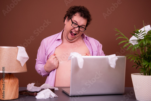 Funny fat man watching adult video. photo