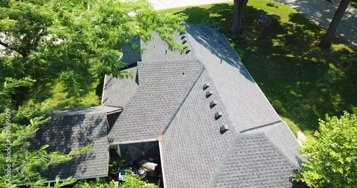 Slow Drone Descent over Modern Roof in Suburbs