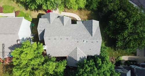 Birds Eye Drone Ascending Quickly away from Nice Home in Wooded Suburb